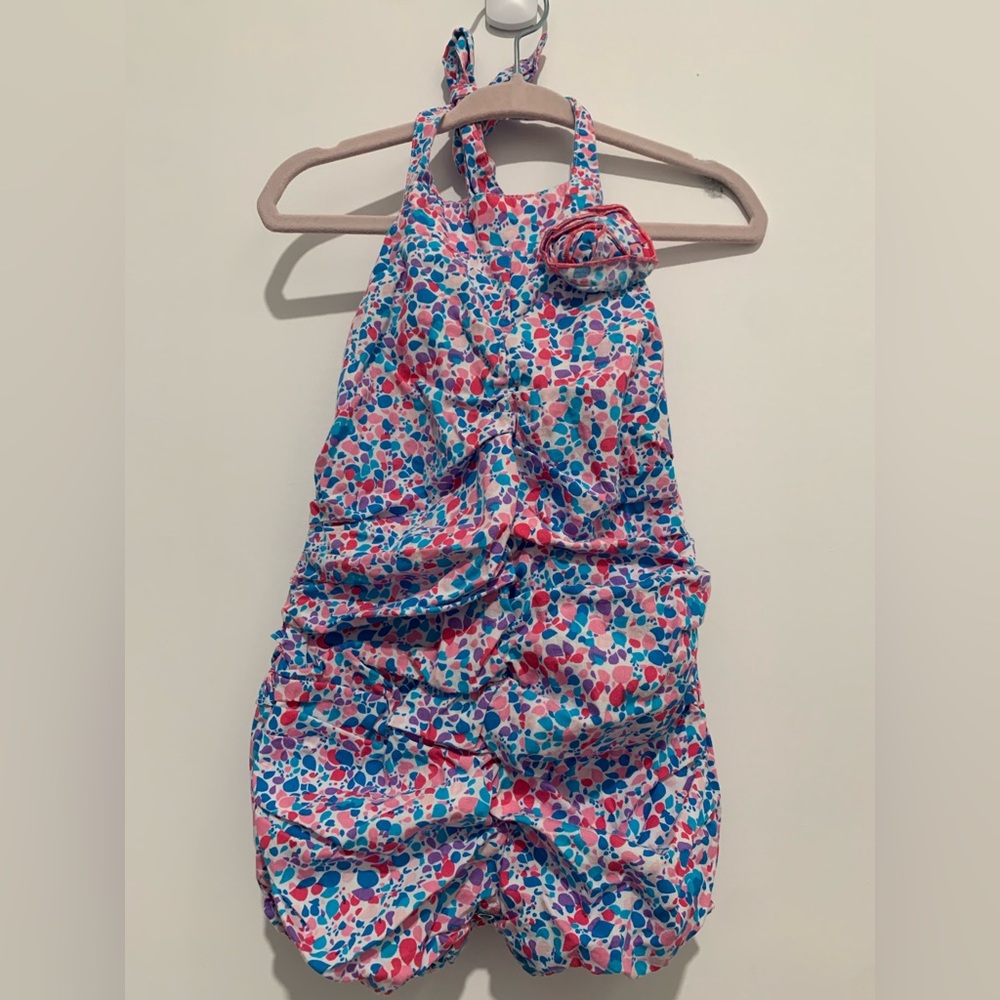 Ruffle butts one piece multicoloured romper with ruffles. Size 12-18 months.